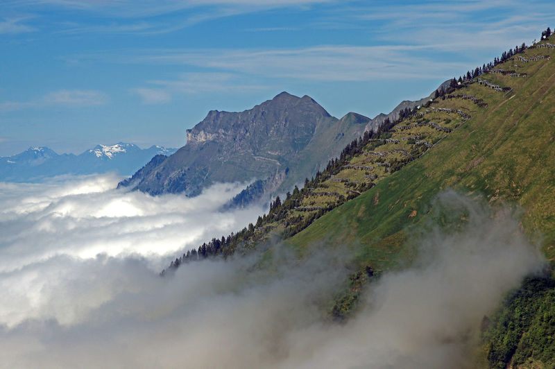 Clouds covering brienzer rothorn mountain against sky
