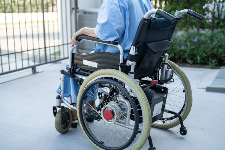 Midsection of woman sitting on wheelchair