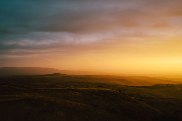 Scenic view of landscape against sky during sunset