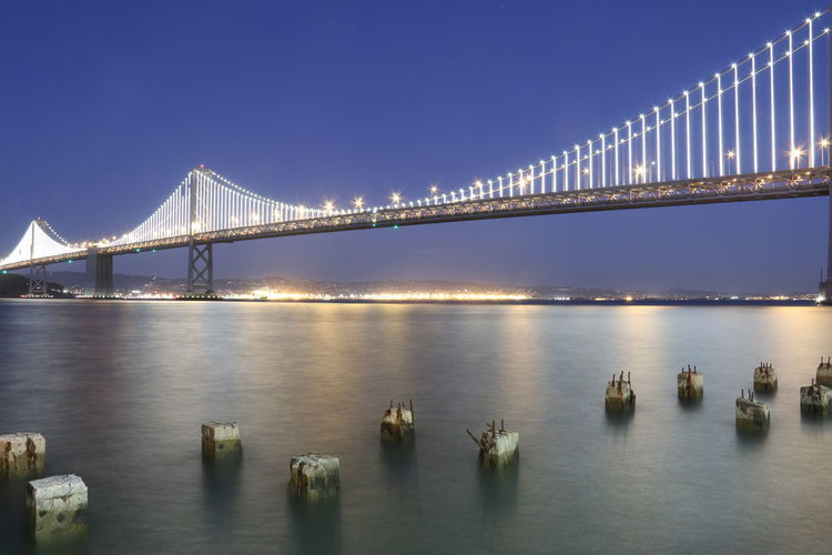 Illuminated bridge over bay at night