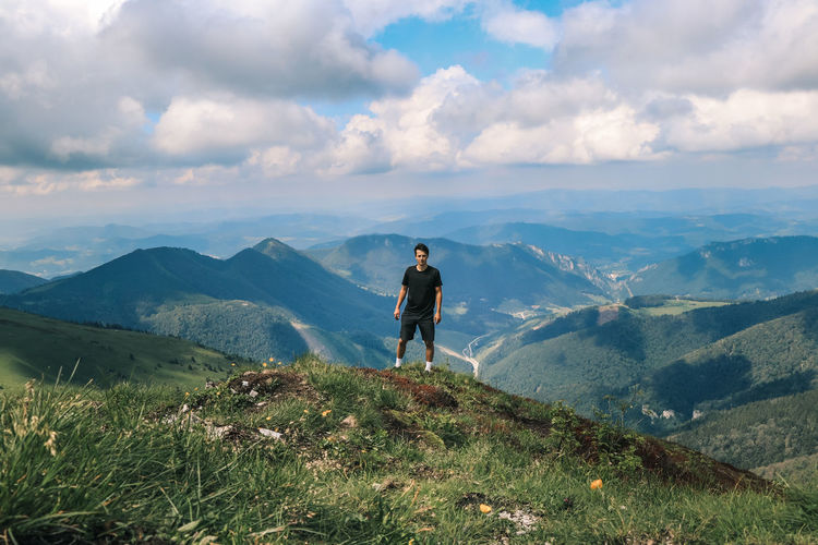Athlete in a black t-shirt poses on top of the mala fatra mountain. climbing mount hromova. a hiker 