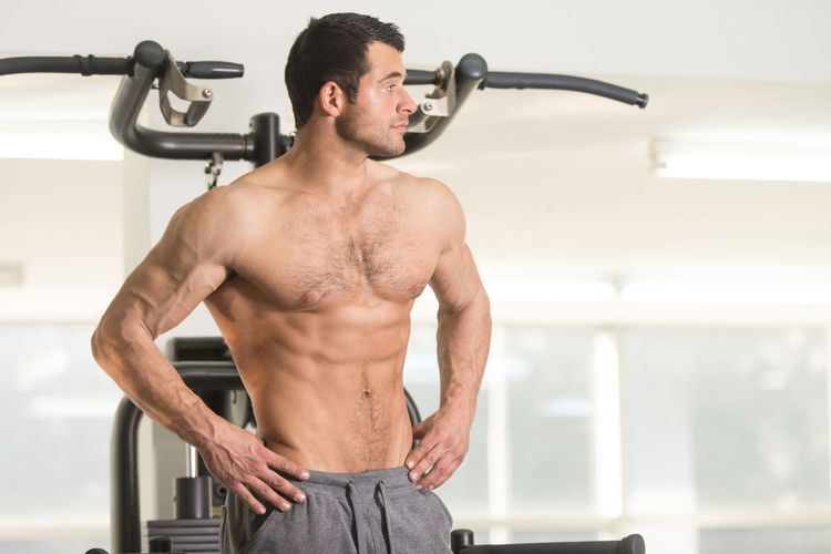 Muscular man exercising in gym