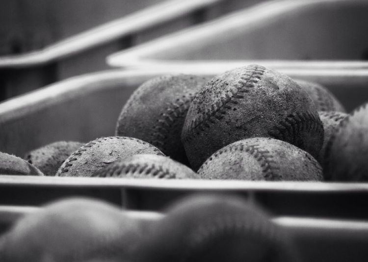 Close-up of baseballs in container