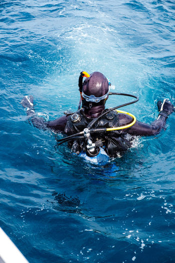 High angle view of person floating on sea