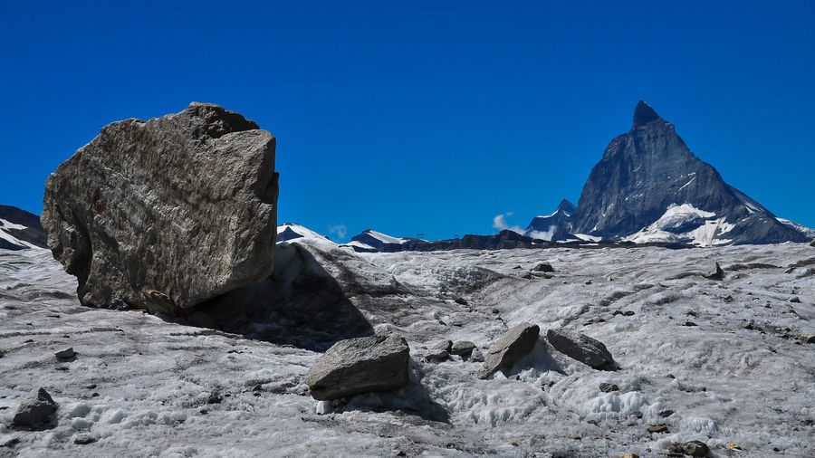 Rock formations against clear blue sky