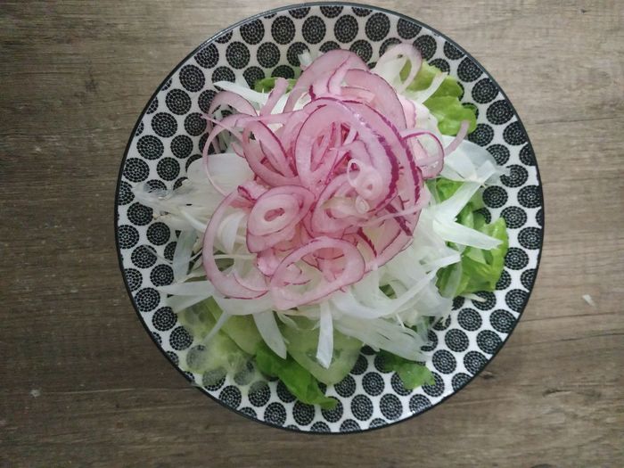 Directly above shot of pink flower in plate on table