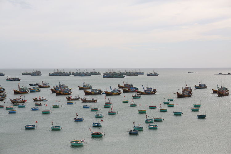 High angle view of boats in sea against sky