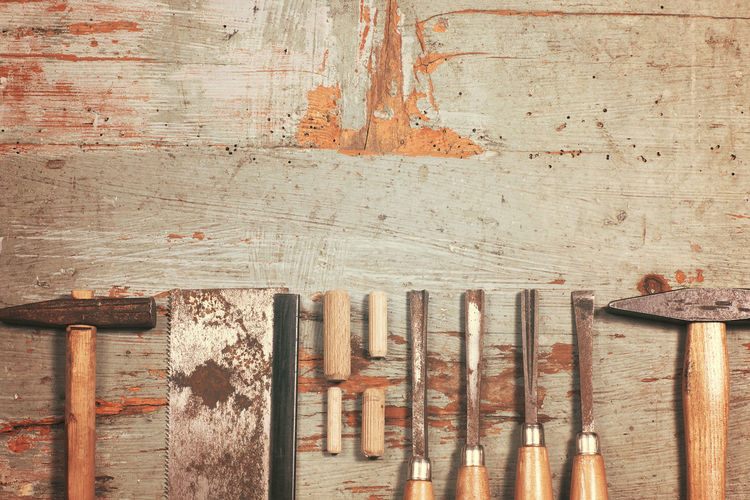 Carpentry tools in row on wooden table