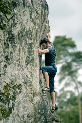 Full length of man climbing on rock