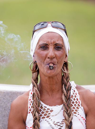 Portrait of senior woman smoking cigar