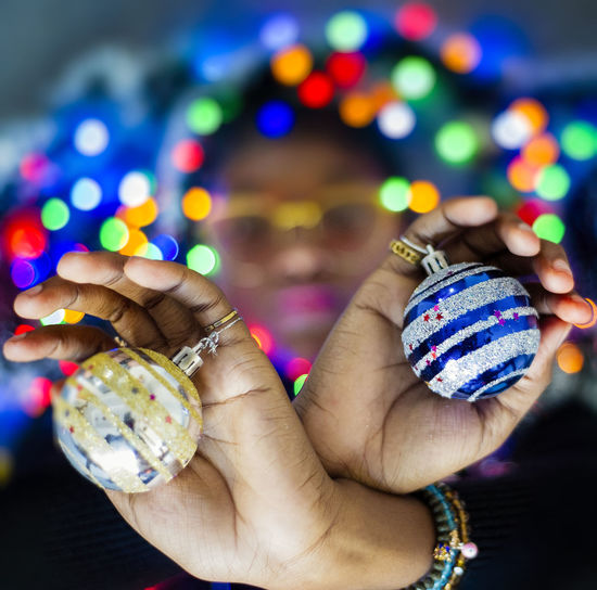 Close-up of woman hand holding christmas decoration balls 