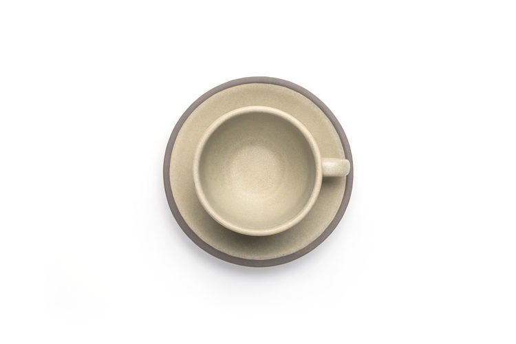 Directly above shot of empty coffee cup against white background