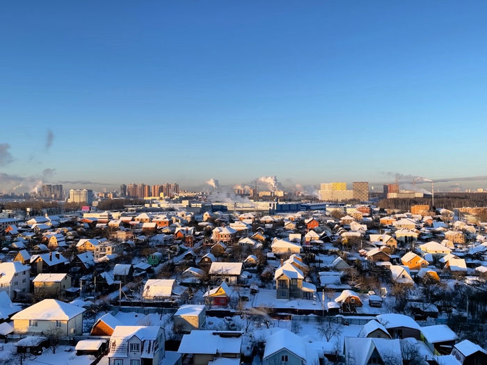 High angle view of townscape against blue sky during winter