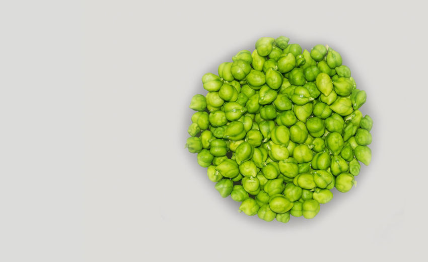 Directly above shot of green beans against white background