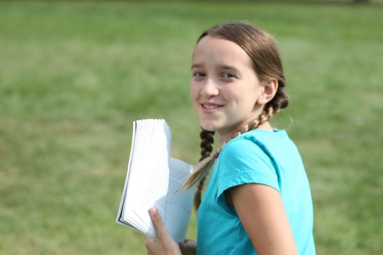 Portrait of smiling girl holding grass