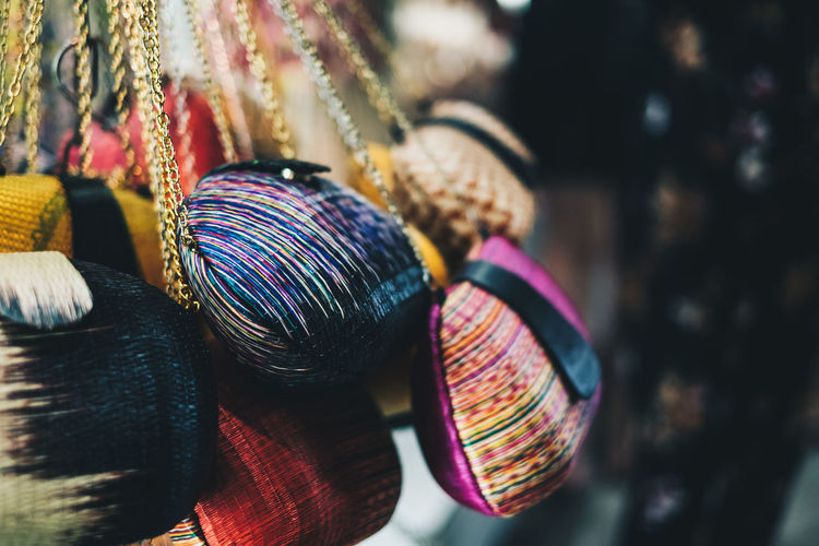 Close-up of multi colored purses for sale at market