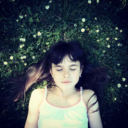 Directly above shot of girl relaxing on field
