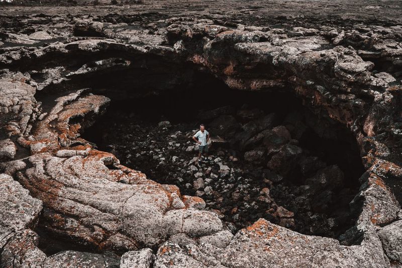 High angle view of man standing in cave