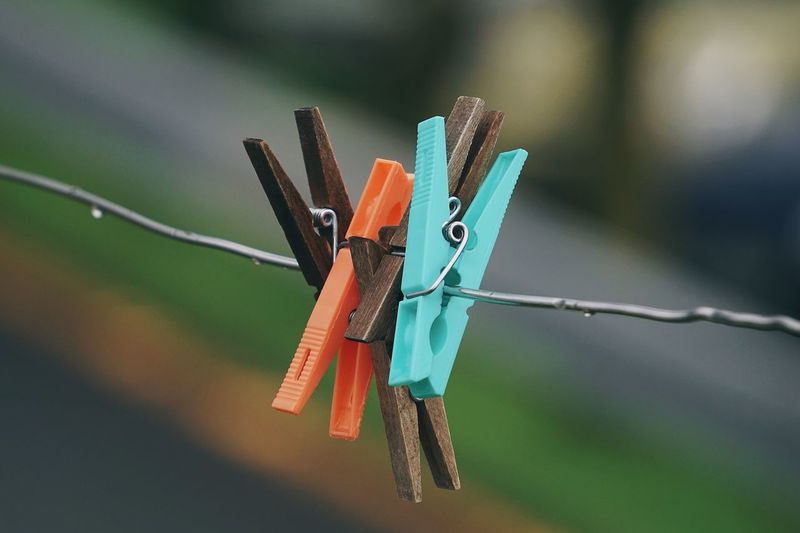 Wooden clothespin in the rope abandoned in the street