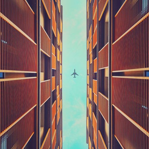 Directly below shot of airplane flying over buildings