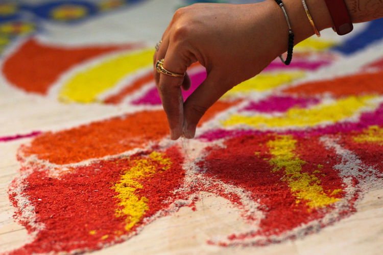 Close-up of hand making mandala