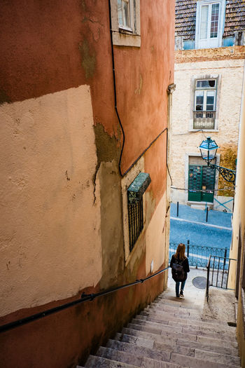 High angle view of woman walking on steps against building