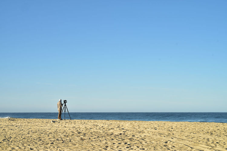Scenic view of beach against clear sky
