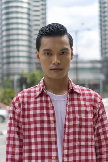 Travel concept, portrait of cute malay asian man outdoor looking at the camera