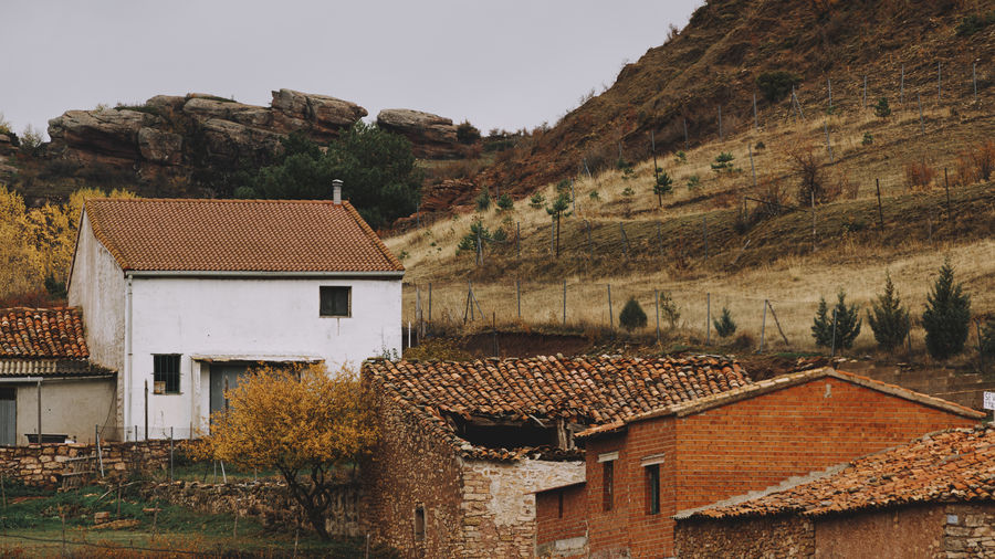 Rural landscape - a collapsed barn and other buildings in a small mountain village.