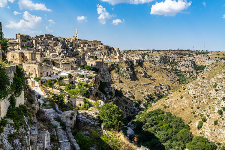 Wide panramic view of matera and gravina canyon seen from rione casalnuovo, basilicata, italy