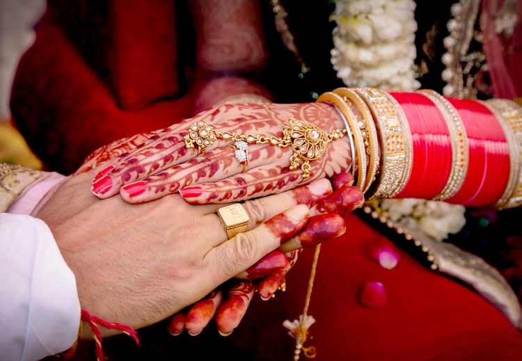 Midsection of bride and groom during wedding ceremony