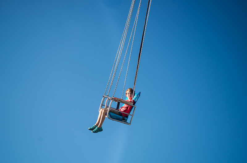 Low angle view of boy on swing 