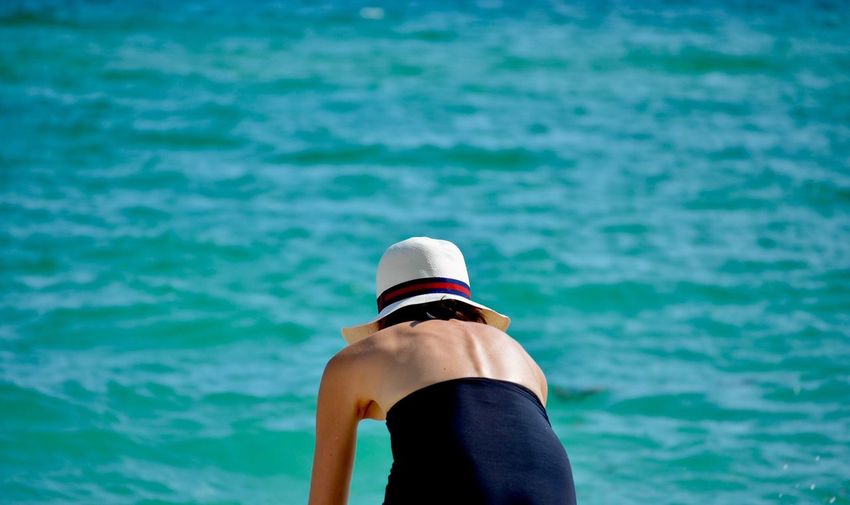 Rear view of woman against sea