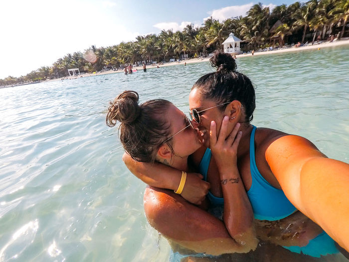 Smiling couple kissing in sea