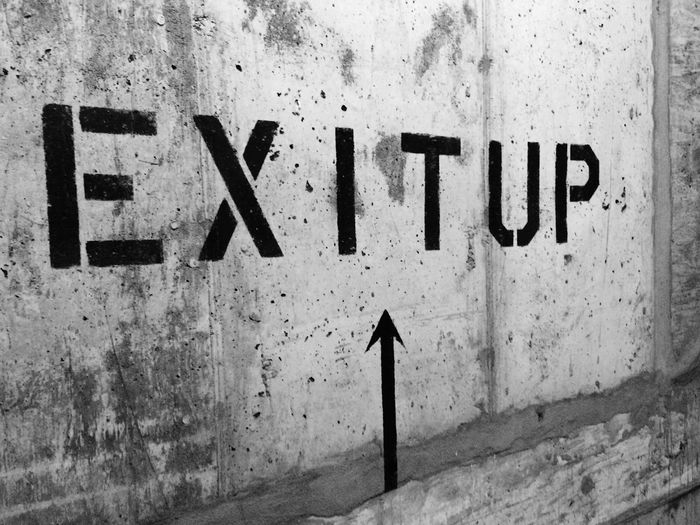 Exit up sign on wall