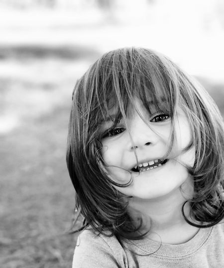 Black and white portrait of cute long haired boy 