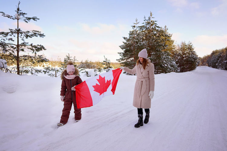 Mother and daughter with the flag of canada