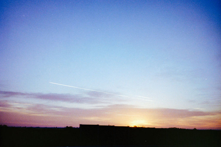 Scenic view of landscape against sky at sunset
