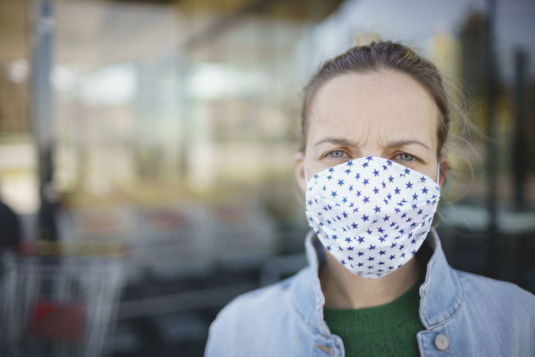 Close-up portrait of woman wearing mask outdoors