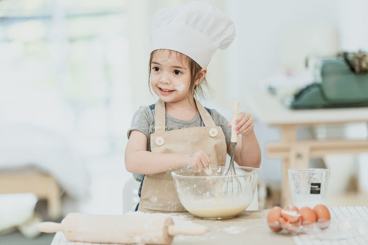 Girl holding ice cream at home