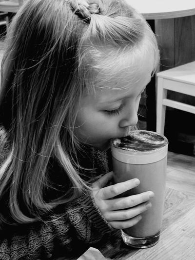 Close-up of girl drinking on restaurant table