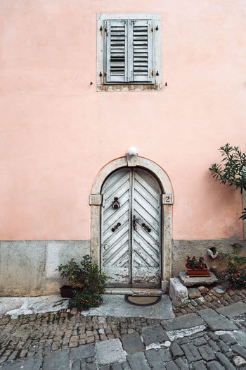 Old white door, on pink house, vintage, chic.
