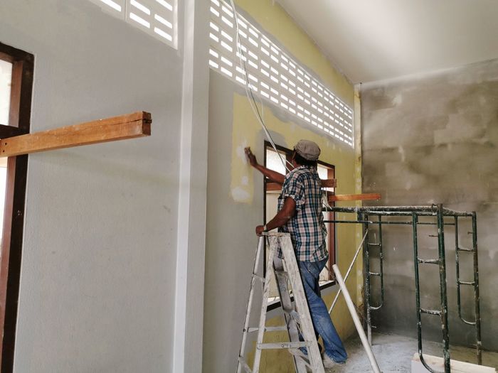 Man working on wall