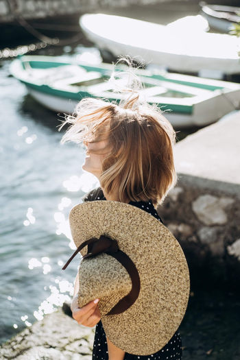 Wind in the hair of a girl sitting by the sea