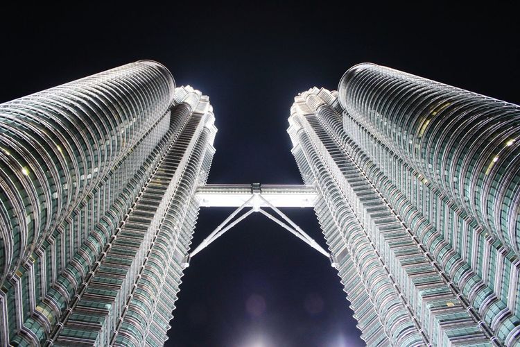 Low angle view of illuminated petronas tower against sky