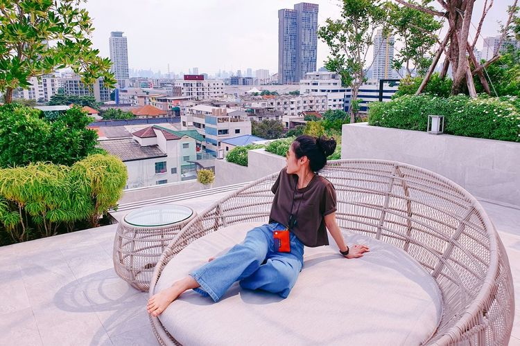 Chilling on the condominium rooftop against the city view on weekends