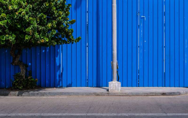 Closed metal gate against blue sky