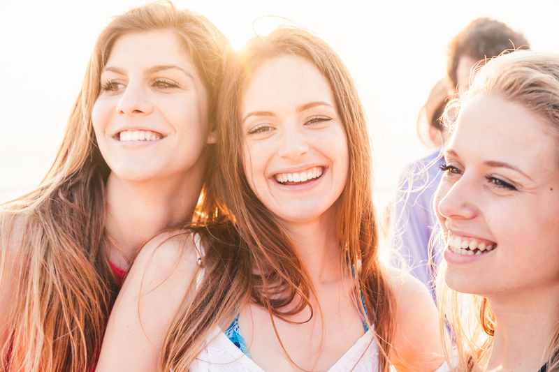 Smiling female friends standing outdoors
