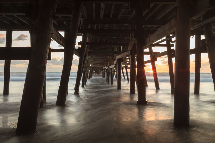 Low angle view of bridge at calm sea