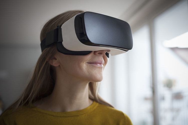 Smiling woman wearing virtual reality glasses